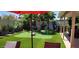 Lush backyard putting green with palm trees, manicured landscaping, and a soothing hot tub at 4617 E Emile Zola Ave, Phoenix, AZ 85032
