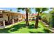 Backyard putting green with covered patio, pool, and lush landscaping for ultimate outdoor enjoyment at 4617 E Emile Zola Ave, Phoenix, AZ 85032