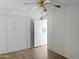 Cozy bedroom with laminate flooring and neutral wall color at 50525 W Whirly Bird Rd, Maricopa, AZ 85139