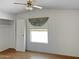 Bright bedroom features laminate flooring, closet and fan at 50525 W Whirly Bird Rd, Maricopa, AZ 85139