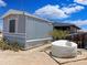 Single-story home featuring a water tank amidst desert landscape at 50525 W Whirly Bird Rd, Maricopa, AZ 85139