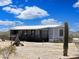 Single-story home featuring covered porch, desert landscaping, and scenic view at 50525 W Whirly Bird Rd, Maricopa, AZ 85139