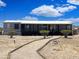 Charming single-story home with covered porch and desert landscaping at 50525 W Whirly Bird Rd, Maricopa, AZ 85139