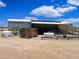 Back of a single story home with solar panels and utilities at 50525 W Whirly Bird Rd, Maricopa, AZ 85139