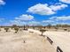 Expansive horse property with ample riding areas and beautiful desert landscaping under a bright blue sky at 50525 W Whirly Bird Rd, Maricopa, AZ 85139