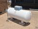 View of a propane tank in backyard, ensuring a consistent energy supply for rural properties at 50525 W Whirly Bird Rd, Maricopa, AZ 85139