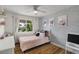 Cozy bedroom with patterned wallpaper, hardwood floors, and ample natural light at 5332 N 81St Pl, Scottsdale, AZ 85250