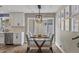 Charming dining area with a glass table, modern lighting, and views of the backyard at 5332 N 81St Pl, Scottsdale, AZ 85250