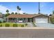 Charming single-story home with a well-manicured front yard and inviting outdoor seating area at 5332 N 81St Pl, Scottsdale, AZ 85250