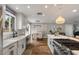 Bright kitchen with white cabinets, stainless steel appliances, and a large island with a cooktop at 5332 N 81St Pl, Scottsdale, AZ 85250