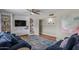 Comfortable living room featuring a ceiling fan, built-in shelving, and a plush blue sofa at 5332 N 81St Pl, Scottsdale, AZ 85250
