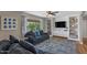 Bright living room with stylish built-in shelves, hardwood floors, and comfortable blue sofas at 5332 N 81St Pl, Scottsdale, AZ 85250