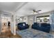 Spacious living room with hardwood floors, comfortable blue sofas, and ample natural light at 5332 N 81St Pl, Scottsdale, AZ 85250