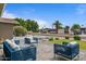 Inviting patio area with stylish wicker furniture and meticulously maintained landscaping and lawn at 5332 N 81St Pl, Scottsdale, AZ 85250