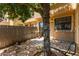 Cozy backyard patio area with mature tree, stone flooring, and wood fence creating a relaxing outdoor space at 5704 E Aire Libre Ave # 1093, Scottsdale, AZ 85254