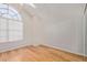 Well-lit bedroom offers hardwood floors, vaulted ceiling, and a large window for ample natural light at 5704 E Aire Libre Ave # 1093, Scottsdale, AZ 85254