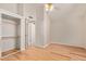 Spacious bedroom includes hardwood floors, a closet, and a view into the hallway with neutral walls at 5704 E Aire Libre Ave # 1093, Scottsdale, AZ 85254
