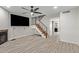 Open-concept living area with updated flooring and a modern staircase at 5704 E Aire Libre Ave # 1093, Scottsdale, AZ 85254