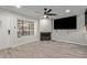 Bright living room featuring a fireplace, stylish flooring, and a modern ceiling fan at 5704 E Aire Libre Ave # 1093, Scottsdale, AZ 85254