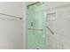 Modern walk-in shower features sleek glass doors, tile, and convenient grab bars for accessibility at 5704 E Aire Libre Ave # 1093, Scottsdale, AZ 85254