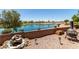 Backyard features a decorative fountain, a fire pit with comfortable seating, and a view of the lake at 6418 S Pinaleno Pl, Chandler, AZ 85249