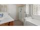 Bright bathroom with a glass enclosed shower, soaking tub, and vanity at 6418 S Pinaleno Pl, Chandler, AZ 85249