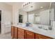 Bathroom featuring double sinks, spacious countertop, and a large mirror at 6418 S Pinaleno Pl, Chandler, AZ 85249