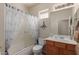 Bathroom with a shower-tub combo, oak vanity, and neutral decor at 6418 S Pinaleno Pl, Chandler, AZ 85249