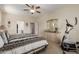 Cozy bedroom featuring a ceiling fan, exercise machine, and neutral color scheme at 6418 S Pinaleno Pl, Chandler, AZ 85249