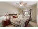 Comfortable bedroom with a ceiling fan, and window view at 6418 S Pinaleno Pl, Chandler, AZ 85249