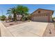 Spacious driveway leading to a two-car garage with desert landscaping at 6418 S Pinaleno Pl, Chandler, AZ 85249