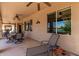 This covered patio is the perfect space to relax and dine outdoors and enjoy the waterfront scenery at 6418 S Pinaleno Pl, Chandler, AZ 85249