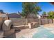 Backyard with a pizza oven, brick wall, raised grill and blue sky at 7340 W Meadowbrook Ave, Phoenix, AZ 85033