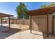 Backyard featuring a shed, brick wall, pizza oven and covered patio at 7340 W Meadowbrook Ave, Phoenix, AZ 85033
