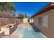 Wide backyard with a shed, brick wall, grill, and covered patio at 7340 W Meadowbrook Ave, Phoenix, AZ 85033