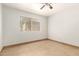 A bedroom with neutral paint and tile, a ceiling fan, and a window with blinds at 7340 W Meadowbrook Ave, Phoenix, AZ 85033