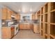 Functional kitchen featuring wood cabinets, a gas stove, and ample counter space for meal preparation at 7340 W Meadowbrook Ave, Phoenix, AZ 85033