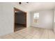 Bright living room with tile flooring, a ceiling fan, and a window looking out to the yard at 7340 W Meadowbrook Ave, Phoenix, AZ 85033