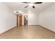 A large living room with light colored tile flooring and a ceiling fan at 7340 W Meadowbrook Ave, Phoenix, AZ 85033