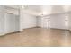 Bright, empty living room featuring tile floors, neutral walls, and sliding glass door to the backyard at 7340 W Meadowbrook Ave, Phoenix, AZ 85033