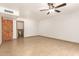 Open living room with light tile flooring, recessed lighting and an attached bath at 7340 W Meadowbrook Ave, Phoenix, AZ 85033