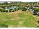Aerial view showcases the community's green space, pool, playground, and well-planned residential layout at 7718 W Pipestone Pl, Phoenix, AZ 85035