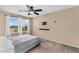 Comfortable bedroom with ceiling fan, TV mount, and sunny windows with views at 7718 W Pipestone Pl, Phoenix, AZ 85035
