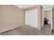 Bedroom featuring neutral walls, carpet, closet, and an attached office space at 7718 W Pipestone Pl, Phoenix, AZ 85035