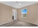 Simple bedroom with neutral walls, carpet, a window, and a stylish chandelier at 7718 W Pipestone Pl, Phoenix, AZ 85035