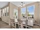 Bright dining room features a table with seating for six, a buffet, and lots of windows at 7718 W Pipestone Pl, Phoenix, AZ 85035