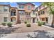 Two-story townhome showcasing xeriscaped front yard and cozy covered front porch with convenient walkway at 7718 W Pipestone Pl, Phoenix, AZ 85035