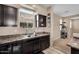 Efficient kitchen space with stainless steel sink, wooden cabinets, and bright natural lighting at 7718 W Pipestone Pl, Phoenix, AZ 85035