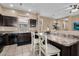 The kitchen has a breakfast bar with chairs, a stainless steel sink, and ample counter space at 7718 W Pipestone Pl, Phoenix, AZ 85035