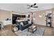 Living area features a ceiling fan, area rug, and a view into the adjacent kitchen at 7718 W Pipestone Pl, Phoenix, AZ 85035